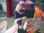 Here’s Eric with our Nephews C and J — here they are tackling him and C is hitting him with padded bowling pins.  Boys sure like to be violent!  Eric is a good sport to play with them. :)